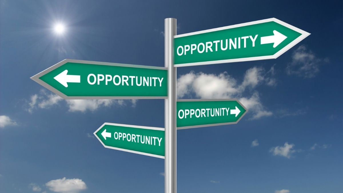 Road signs pointing in multiple directions all labelled Opportunity against a blue sky